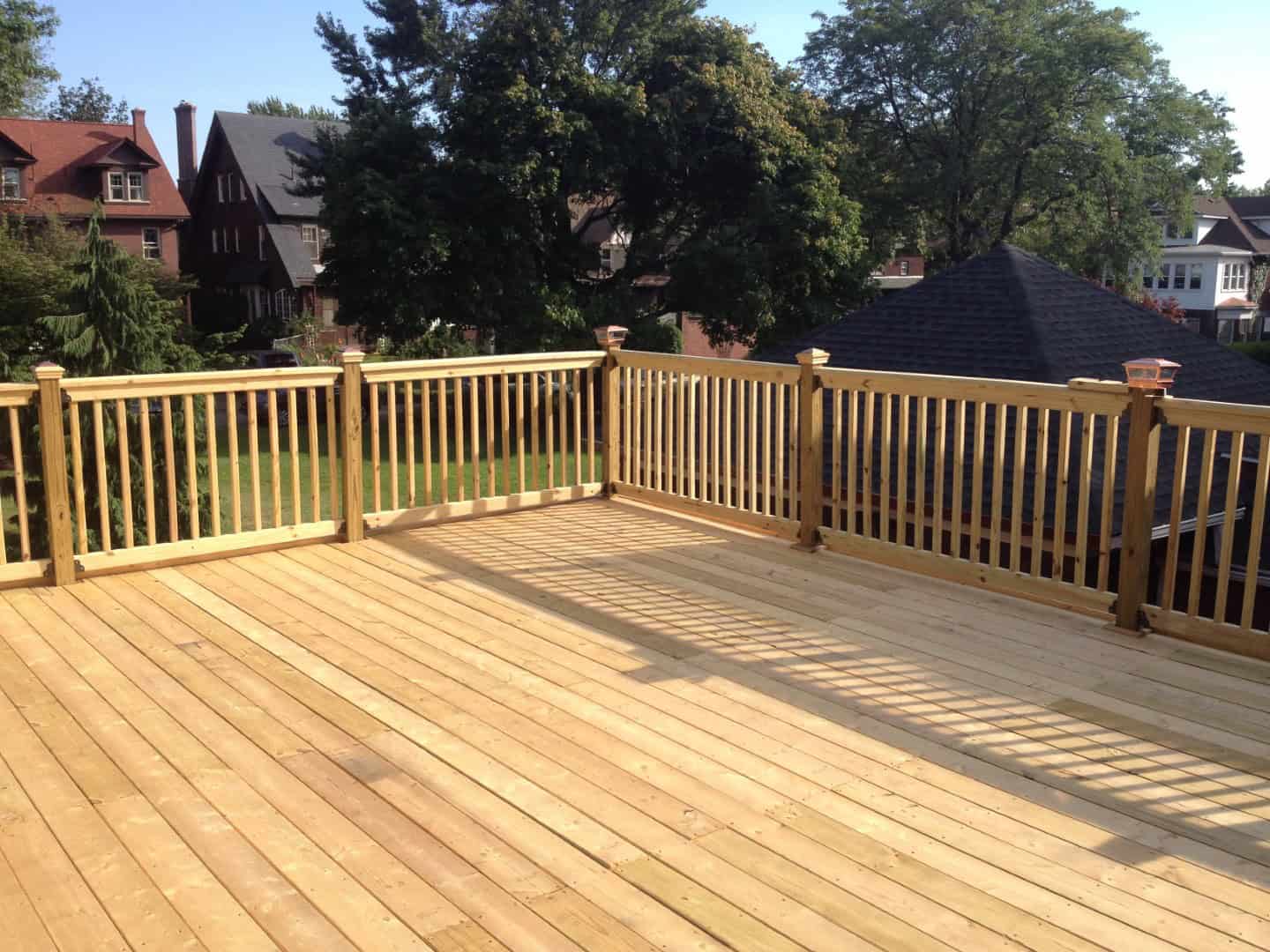 Construction of large wood deck on flat roof garage.